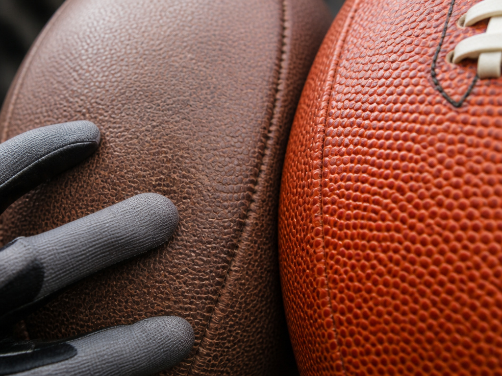 Close-up comparison of broken-in versus new leather football pebble grain texture.